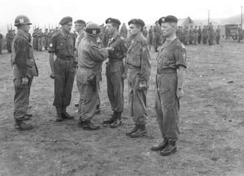 Sgt. Van Hamme being decorated, to his left Cpl. Leunis and Sgt. Van Damme are awaiting theirs ...